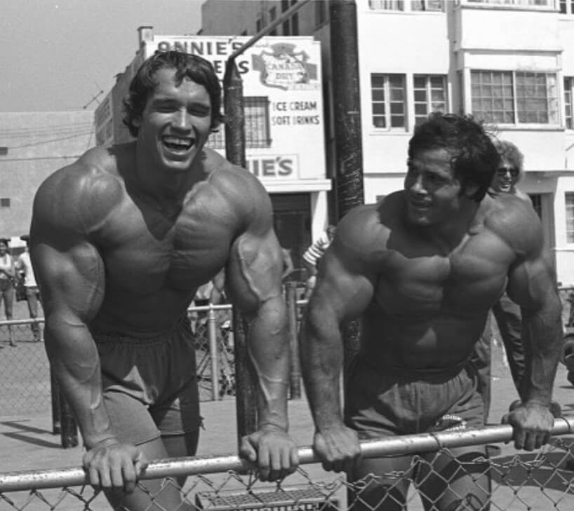 arnold shwarzenegger and franco columbo shirtless post resistance training and smiling symbolizing it as a viable treatment for depression