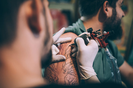 man getting a tattoo and it effects on sweating