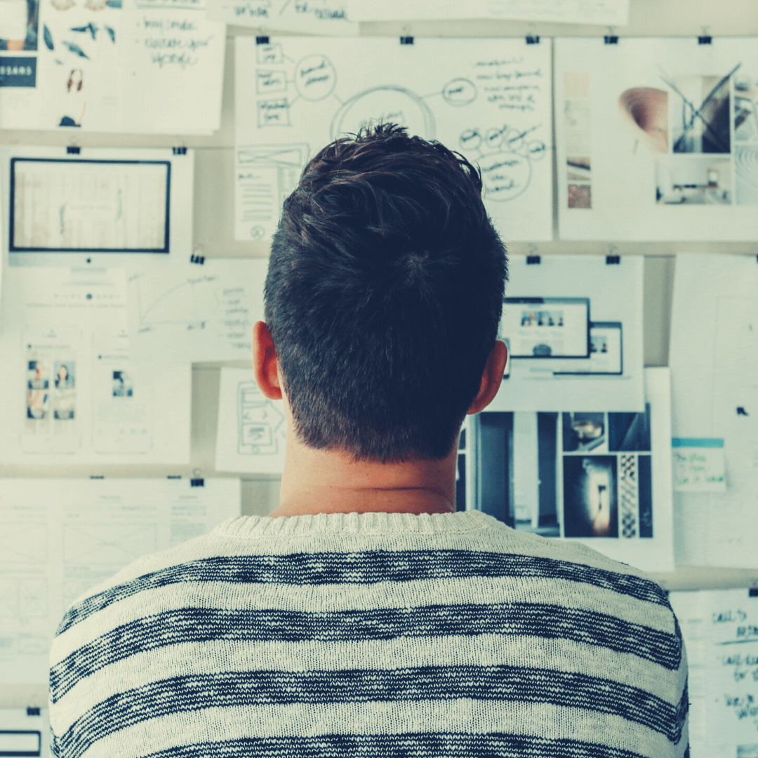 man looking at evidence based practice on a wall