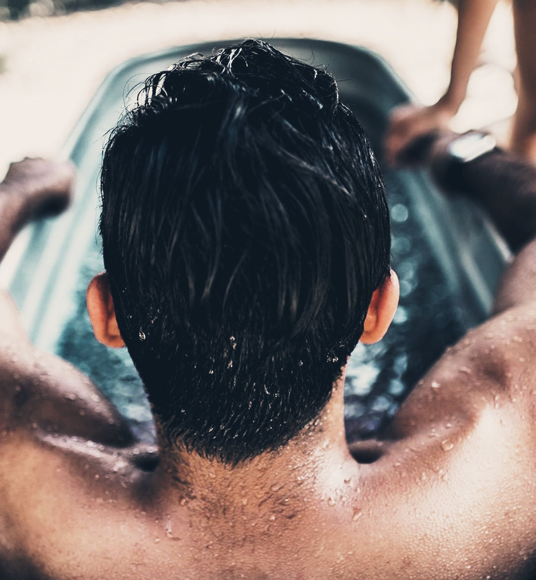 man sitting in ice bath for post-workout recovery